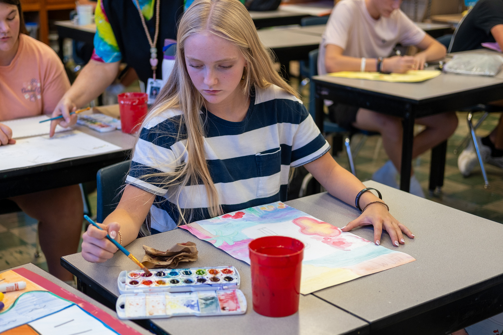 A student works on a watercolor painting project