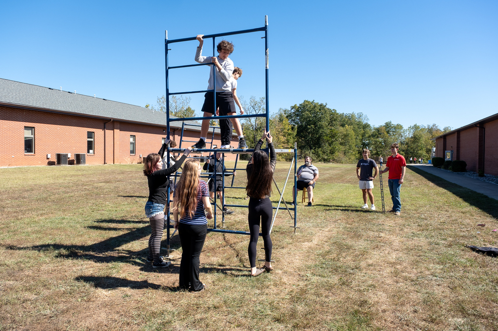 Students work together to assemble scaffolding.