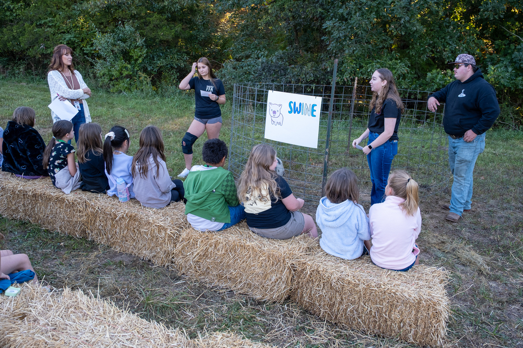 Ag students lead a presentation about pigs for elementary students.