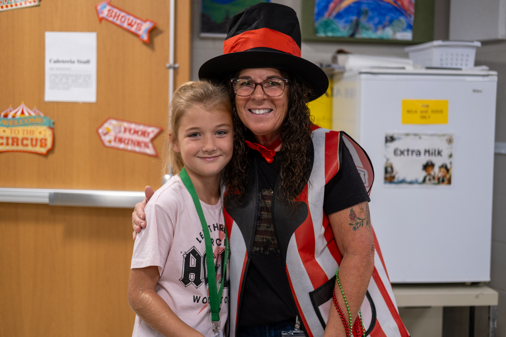 Cafeteria staffer poses with a student during school lunch week