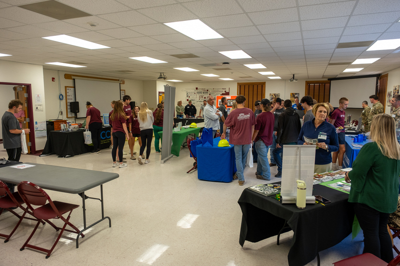 Students speak with representatives during a college and career fair.