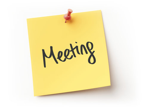 Yellow sticky note pinned with a red thumbtack, with the word “Meeting” written on it in black script.