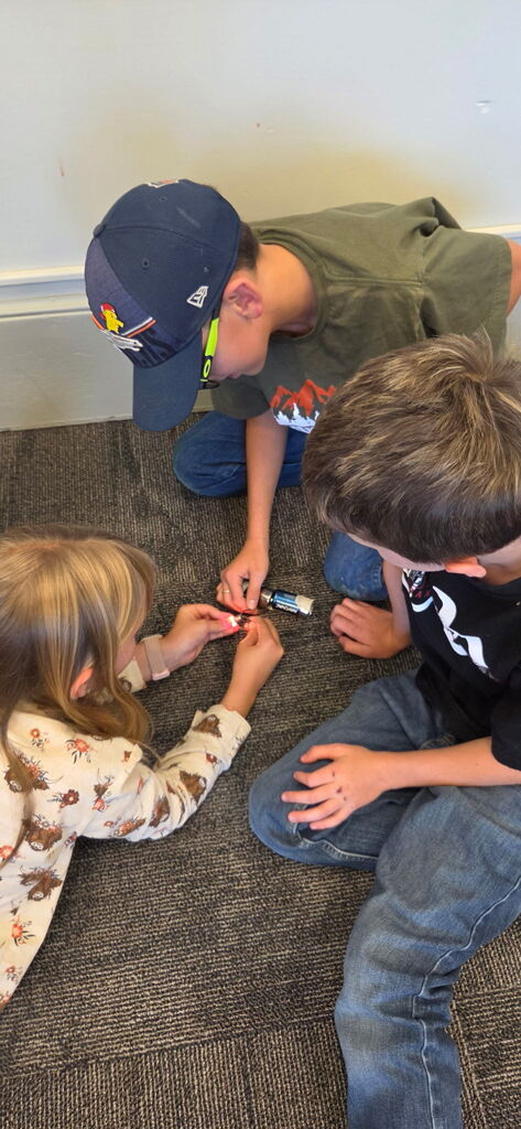 Working on their lightbulbs for Granny's flashlight.