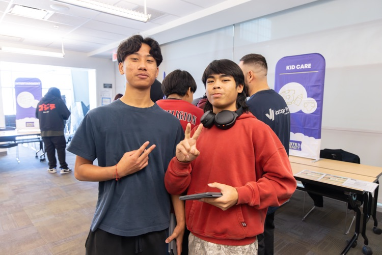 two students posing with peace signs