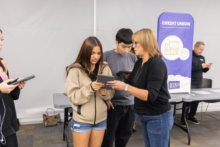 girl with ipad gets help from woman