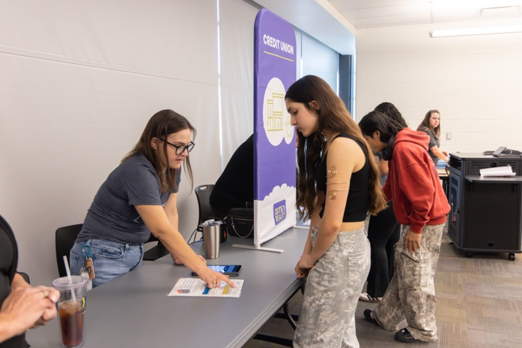 adult helping student with activity