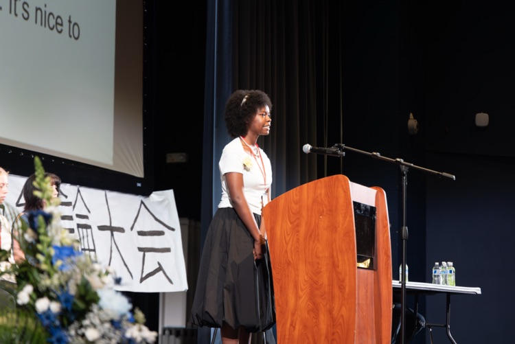 student at a podium reciting a speech