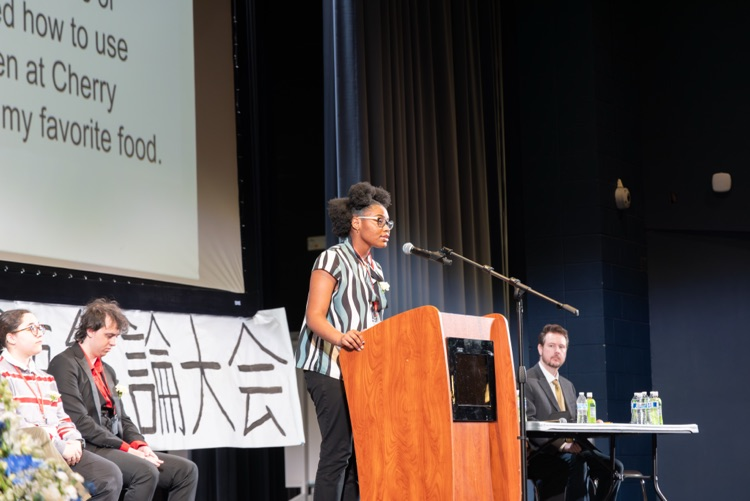 student at a podium reciting a speech