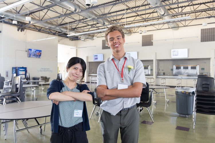 teacher and student pose for a photo