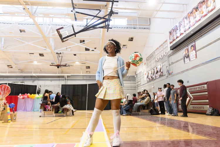 girl in pink skirt, white shirt, light blue jacket