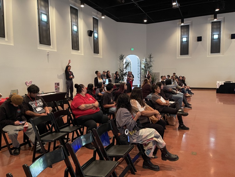 audience sitting in rows of chairs