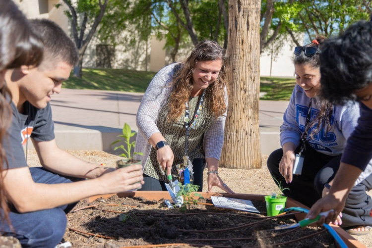 Carly Bacha plants seeds in a garden