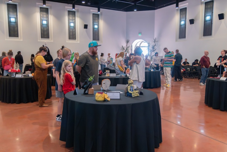 Crowd of people looking at student artwork
