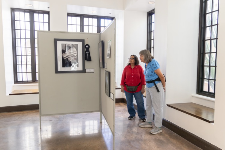 Crowd of people looking at student artwork