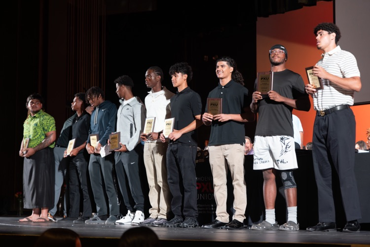 students and coaches on stage at the All PXU sports awards