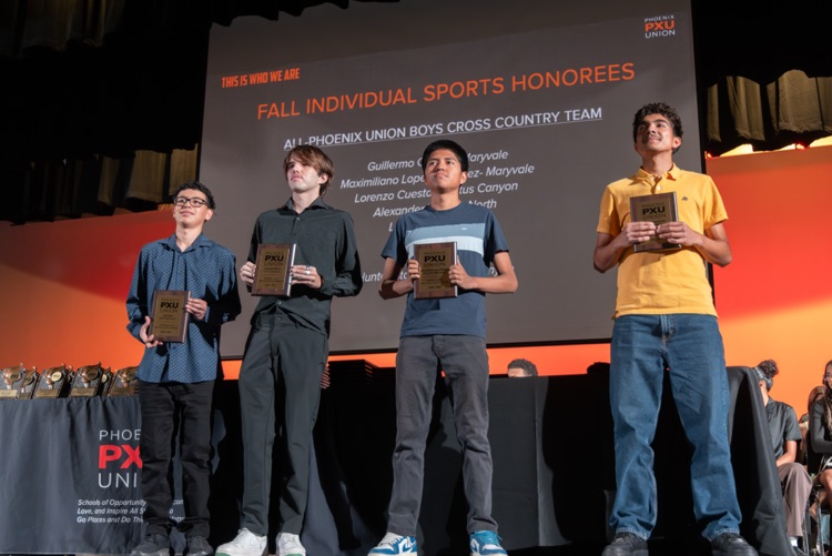 students and coaches on stage at the All PXU sports awards