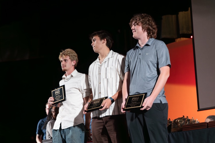 students and coaches on stage at the All PXU sports awards