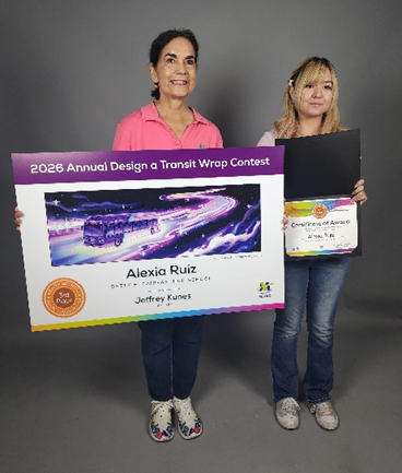 Alexia Ruiz with Valley Metro representative Dolores Nolan. Alexia holding certificate award and Dolores holding the 2026 Annual Design a Transit Wrap Contest with Alexia's art placing 3rd place