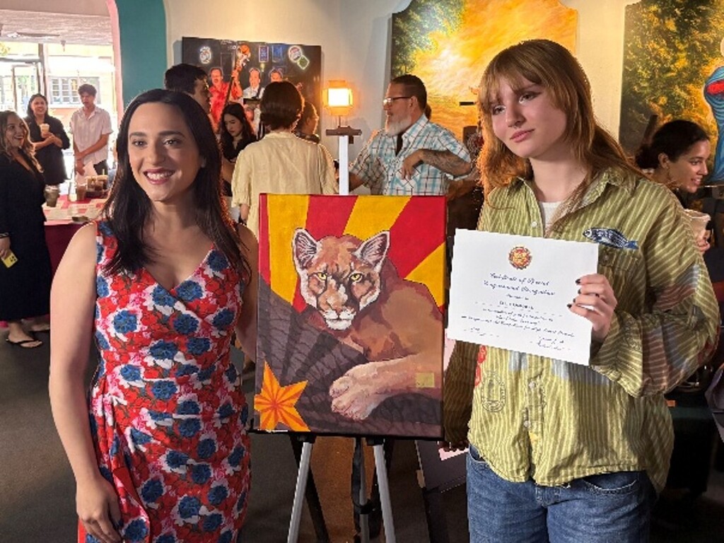 Ellie is pictured with Congresswoman Yassamin Ansari and her outstanding art placed 2nd place