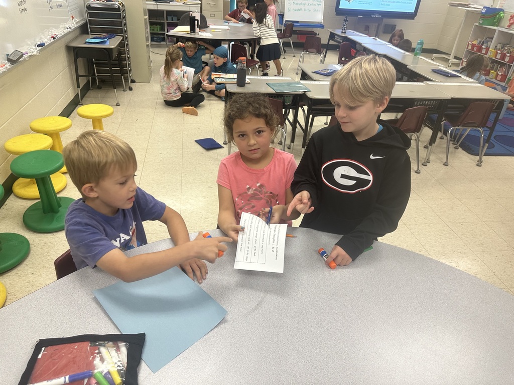 Mrs. Shealey's class working together on writing a paragraph.