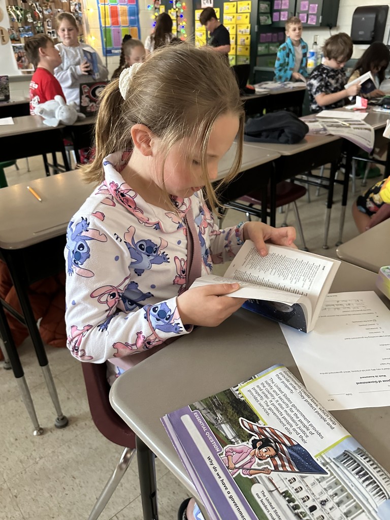 Third graders receive dictionaries.