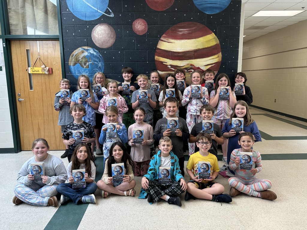 Third graders receive dictionaries.