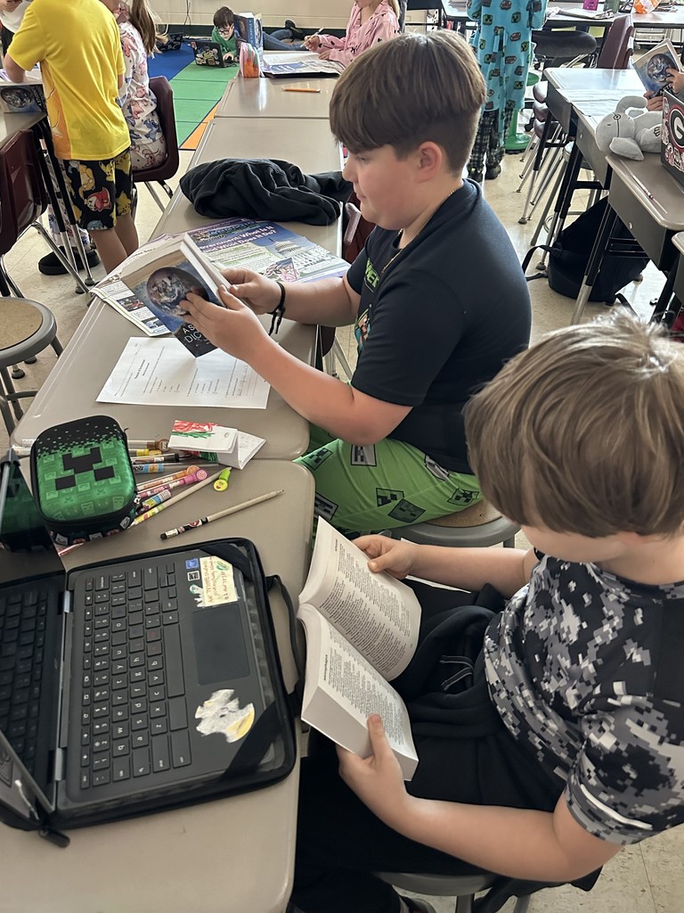Third graders receive dictionaries.