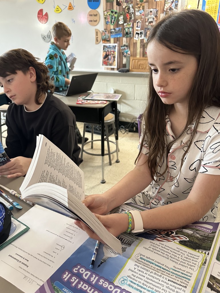 Third graders receive dictionaries.