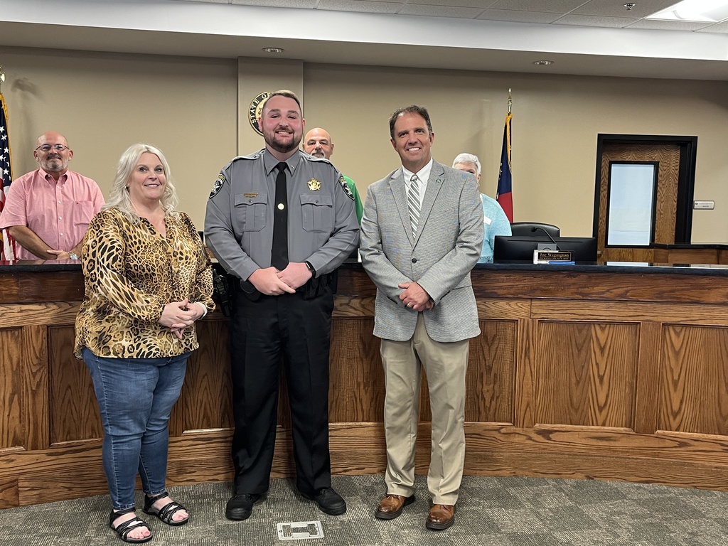 Photo honoring Deputy Blake McClure. L-R Amy Gibson, Blake McClure, Dr. Travis Thomas