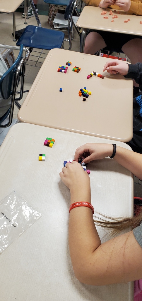 Algebra students building squares and cubes