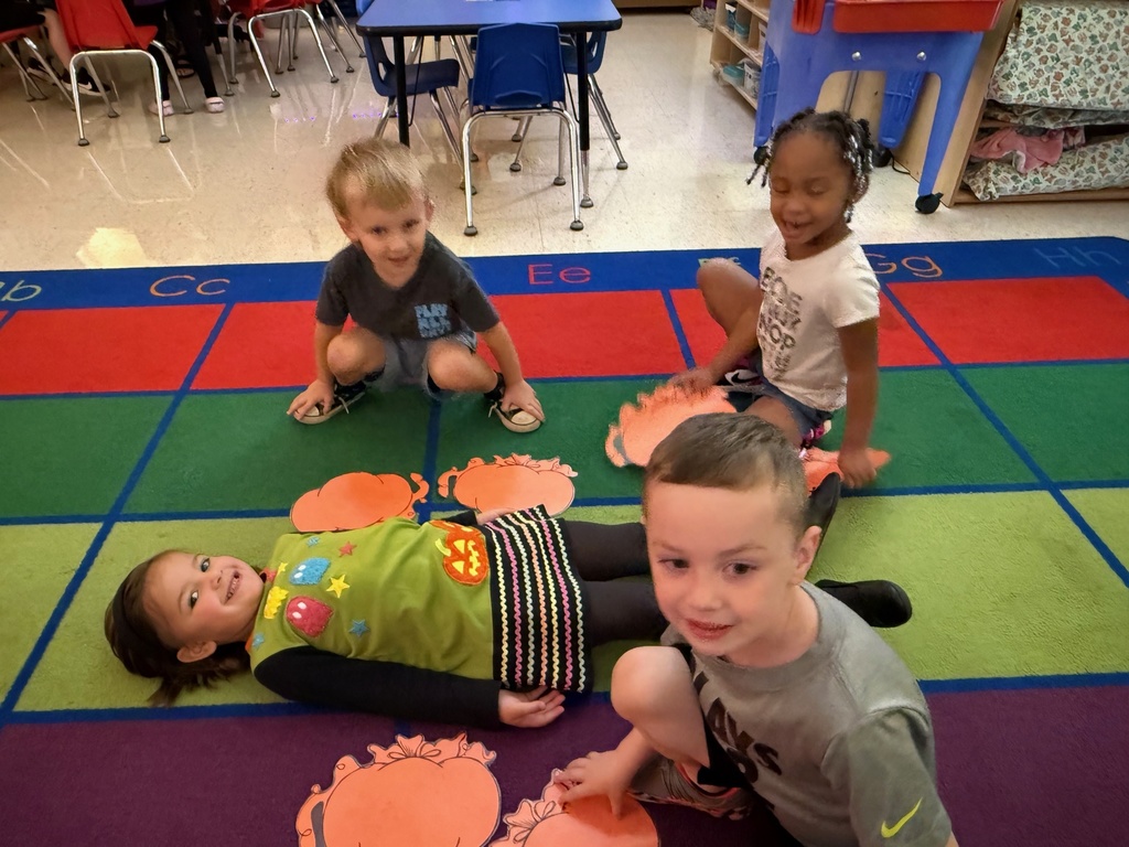 Measuring with pumpkins in Mrs. Anderson's PreK.