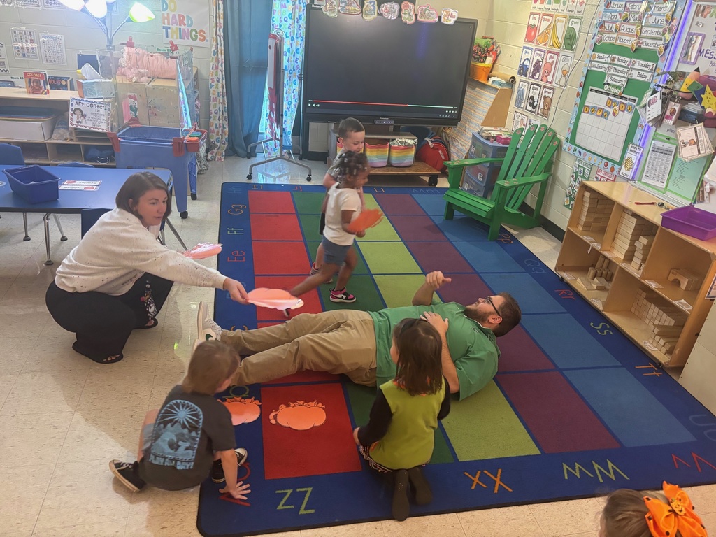 Measuring with pumpkins in Mrs. Anderson's PreK.