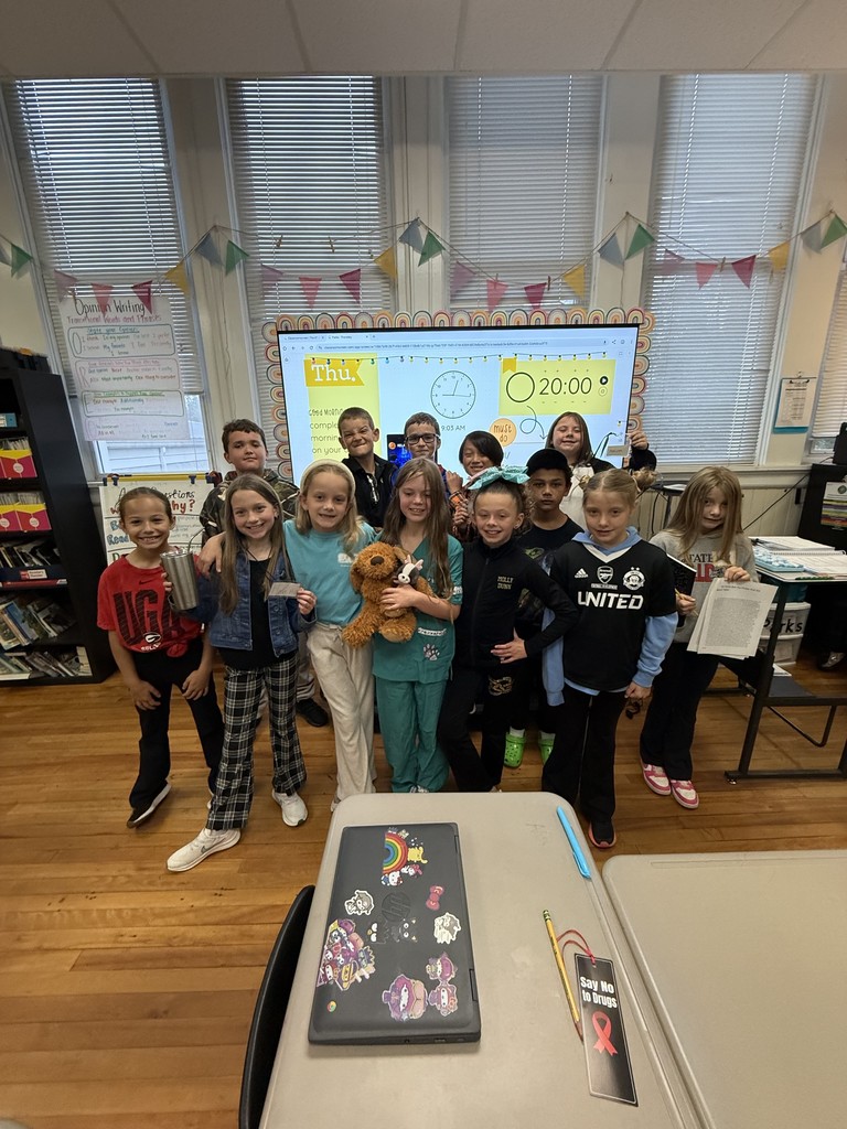 Group of kids standing in front of a classroom dressed in career day clothes for Red Ribbon Week