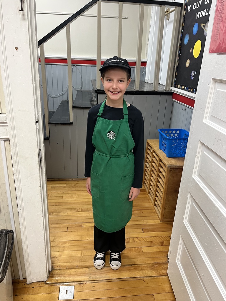 Female student standing in a stairwell dressed as a barista from Starbucks for career day/ Red Ribbon Week