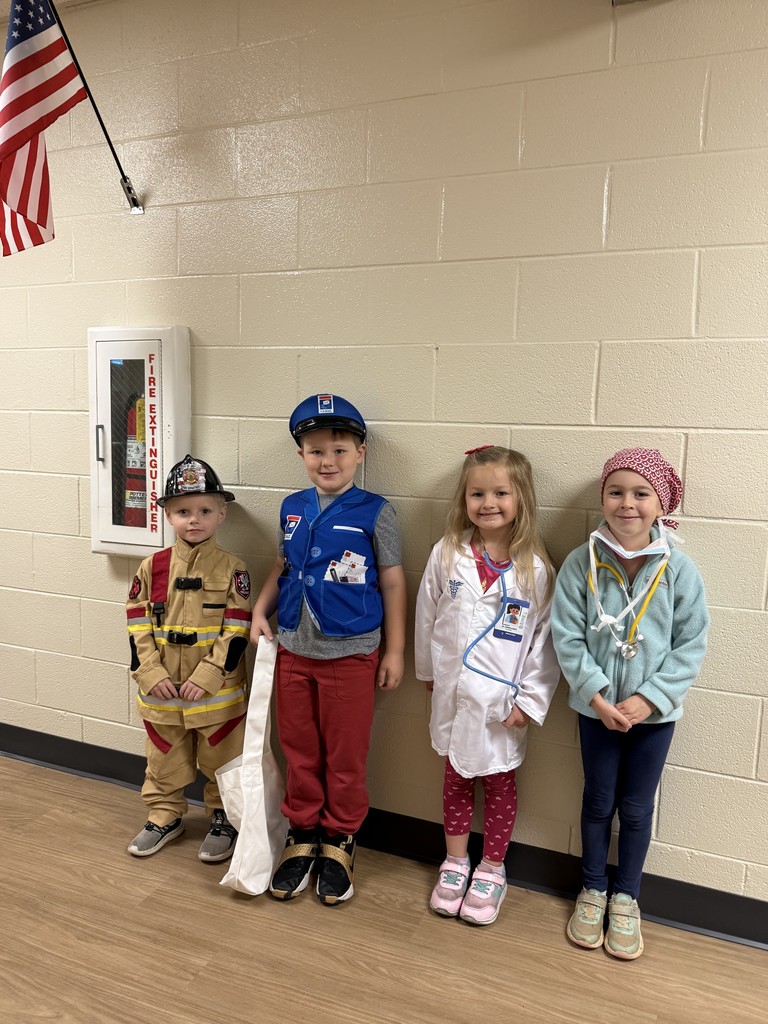 Group of kids standing in a hallway dressed in career day clothes for Red Ribbon Week