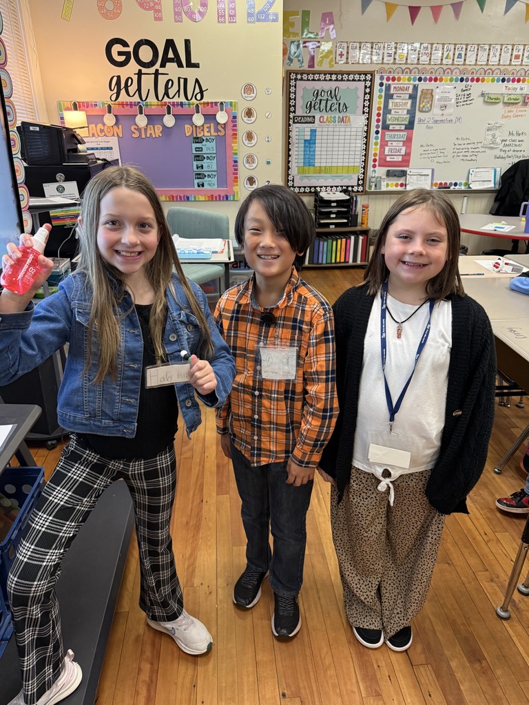 Three students  standing in front of a classroom dressed in career day clothes for Red Ribbon Week