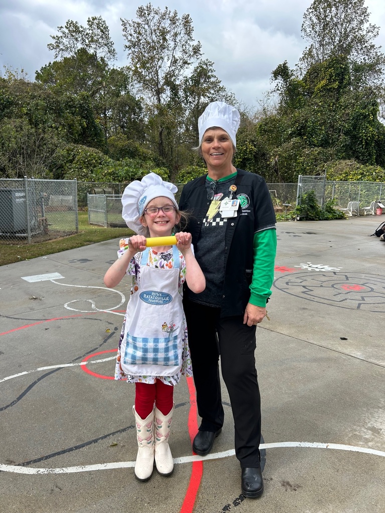 Cafe Manager and student standing  outside both dressed as Cafeteria workers on career day  for Red Ribbon Week