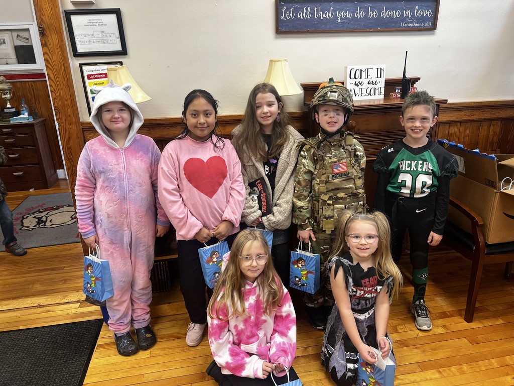 Group of student standing in front office holding a gift bags