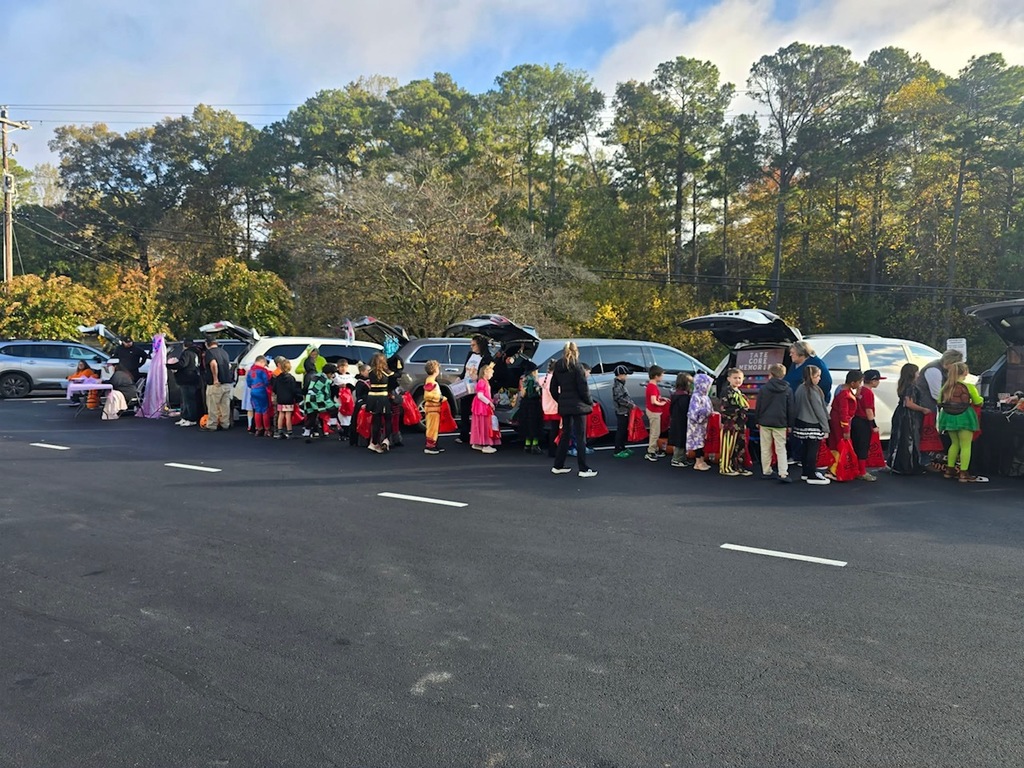Picture of cars decorated for trunk or treating with a classroom of children
