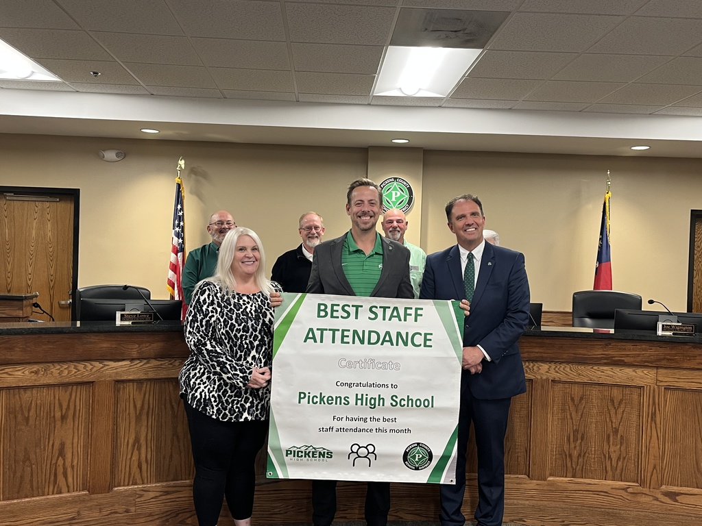 Principal Matt Combs accepting Best Staff Attendance banner