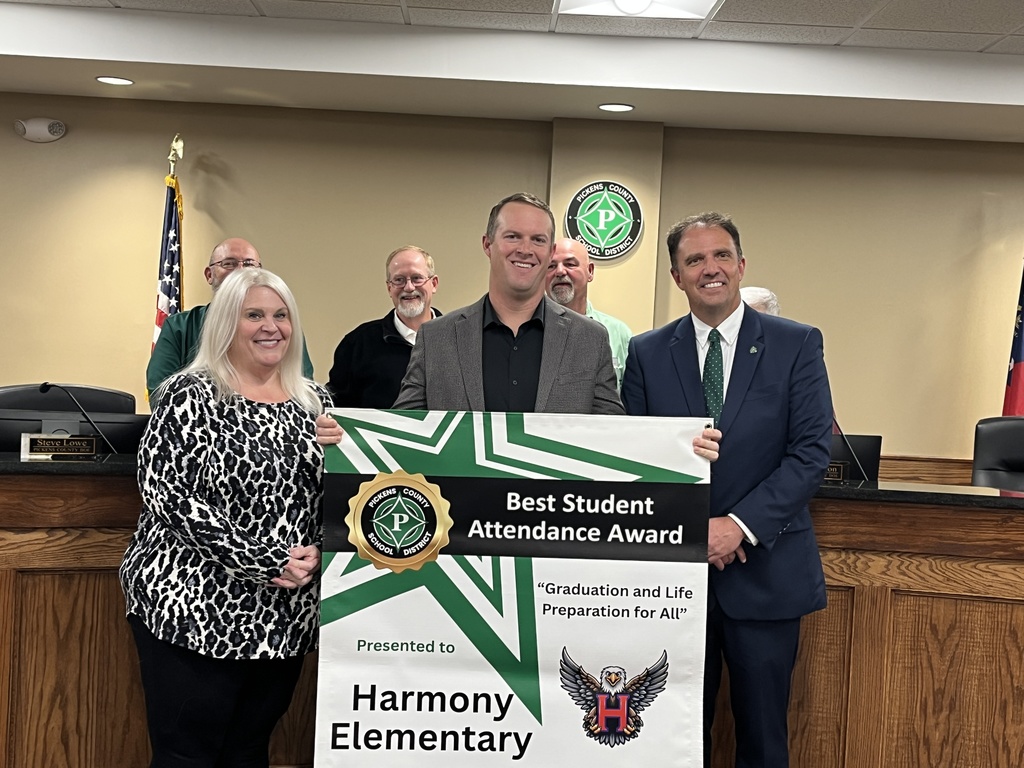 Principal Stephen Hunter accepts Best Student Award banner