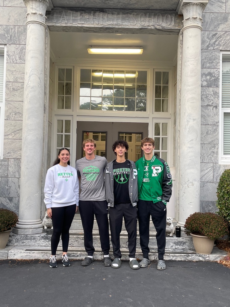 Group of high school student standing in front of school entrance