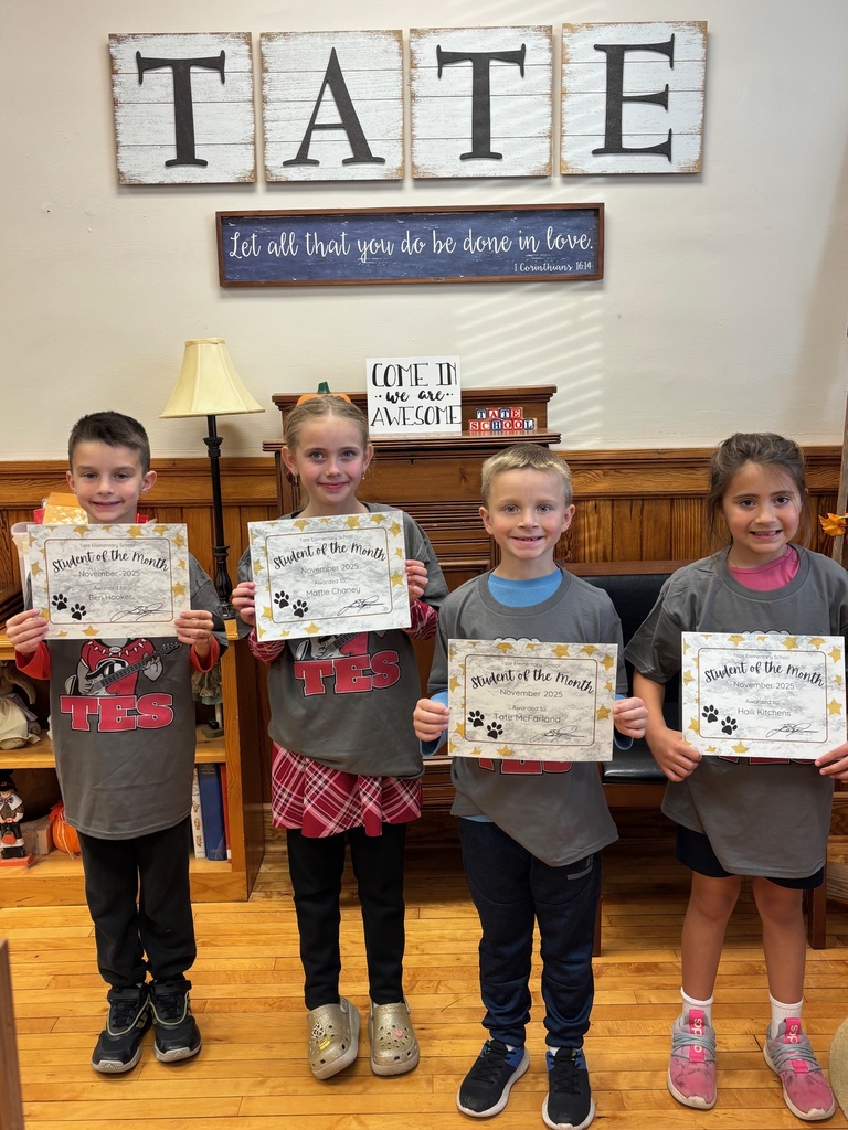Group of kids in the front office holding certificates