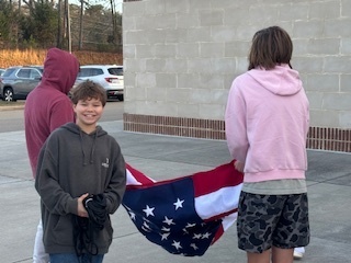 Students unfolding the flag