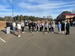 Students and teachers watching the solar cars go