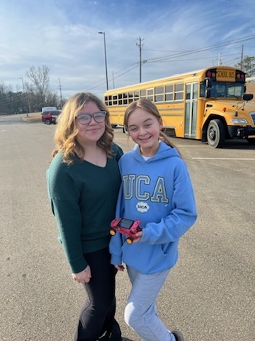 Two students posing with their solar car