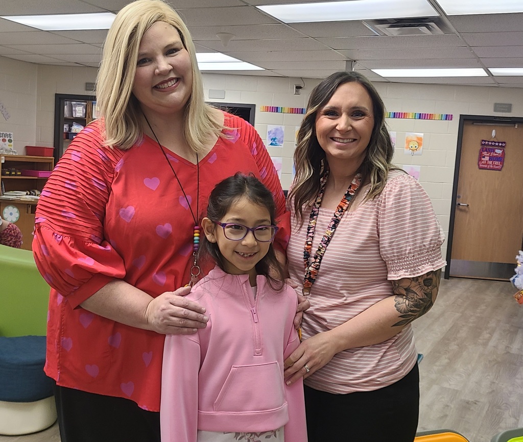 two women and a child standing together 