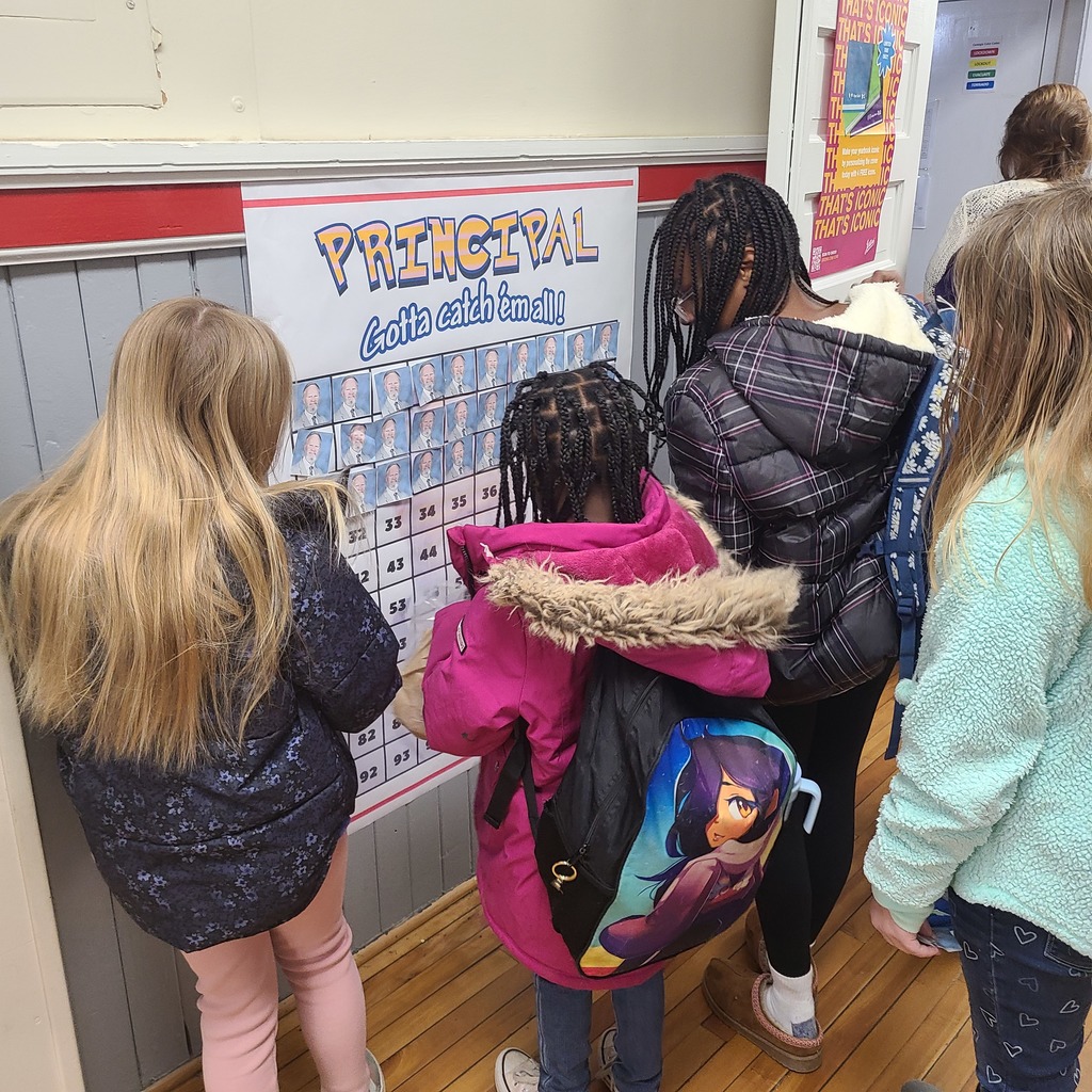 Students in hallway adding pictures to a chart