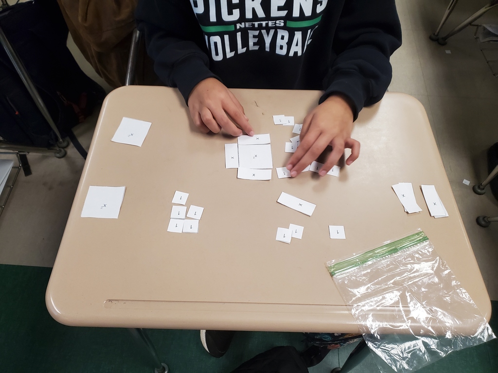 Student working with algebra tiles