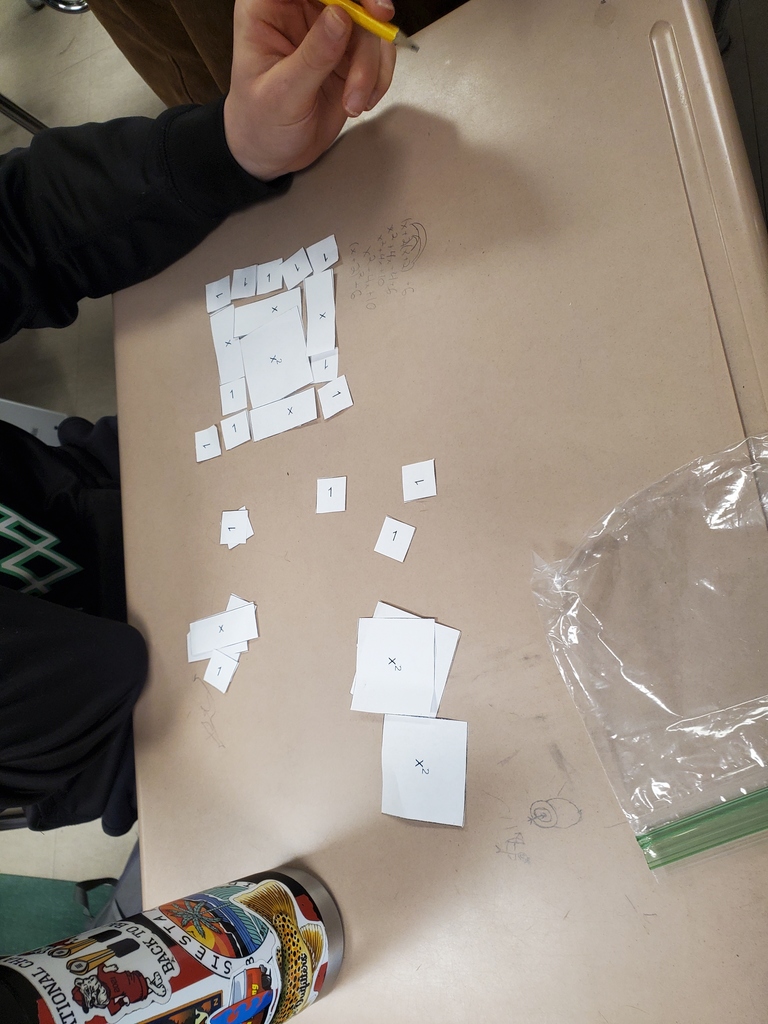 Student working with algebra tiles